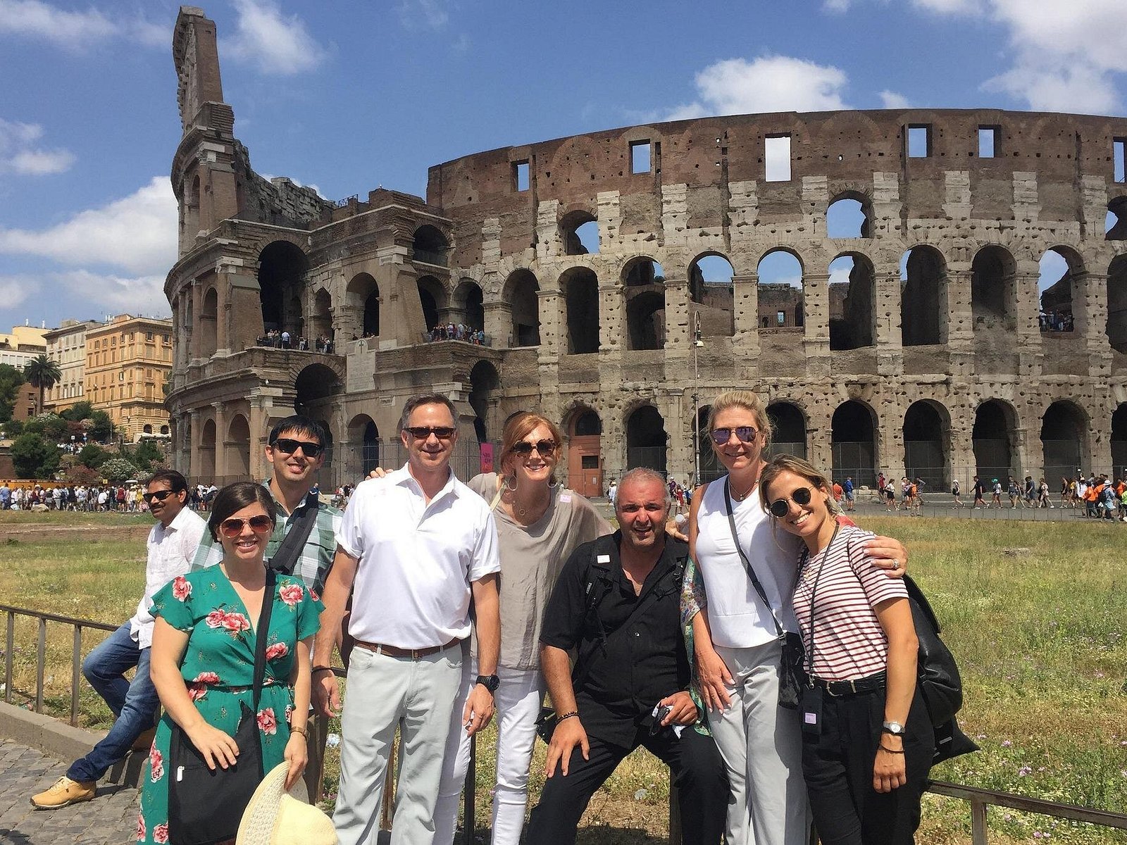 A small visitor group beside the Colosseum.