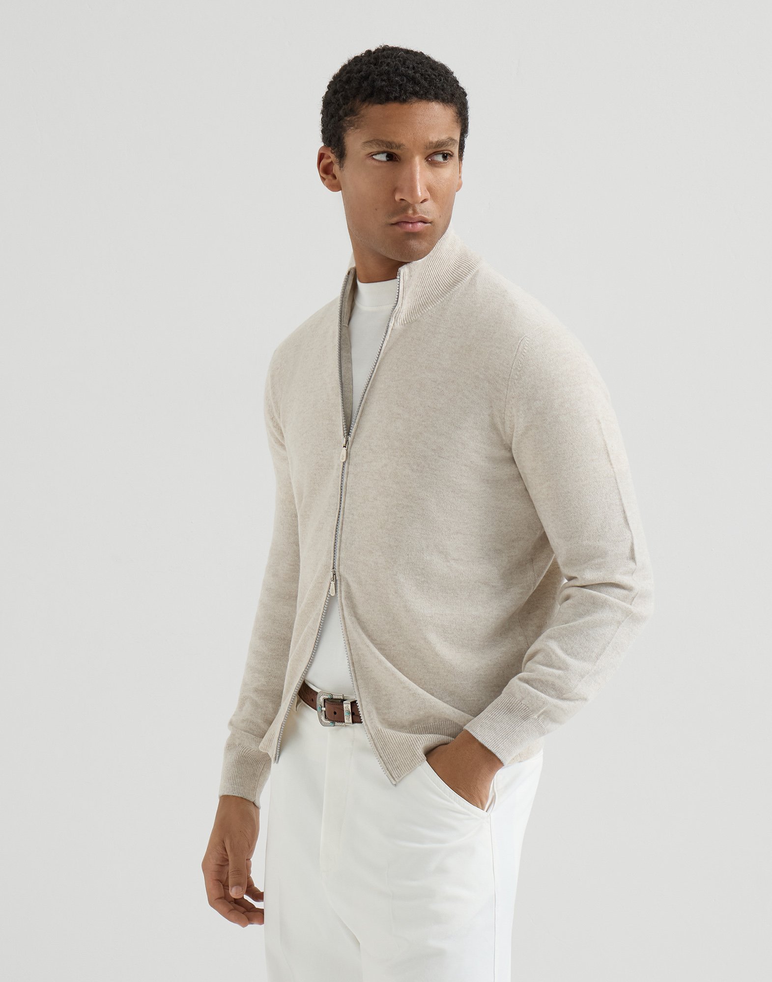 Man wearing a light cashmere zip cardigan with a white T-shirt
