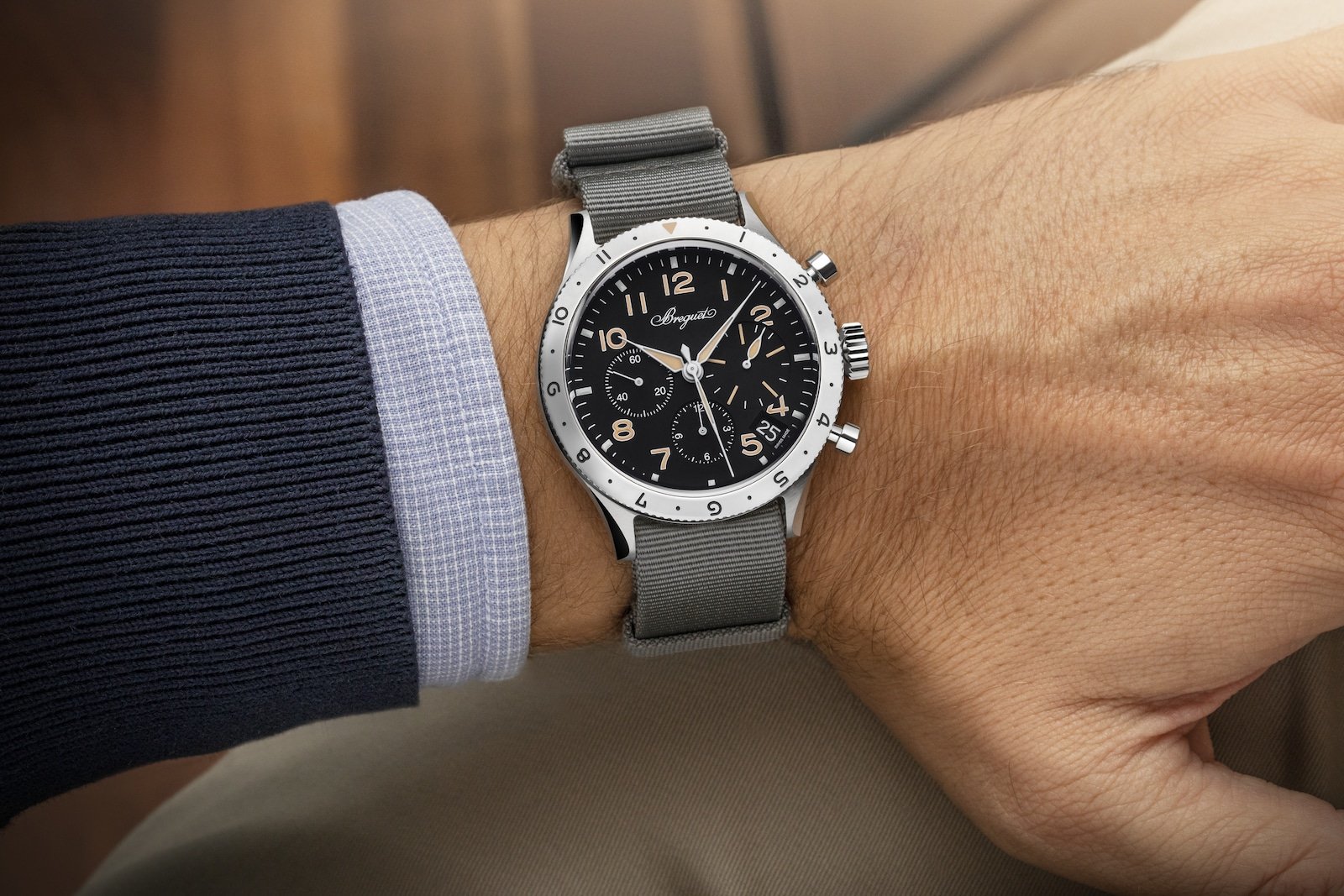 Model wearing a Breguet Type XX watch with a tailored jacket and shirt cuff.