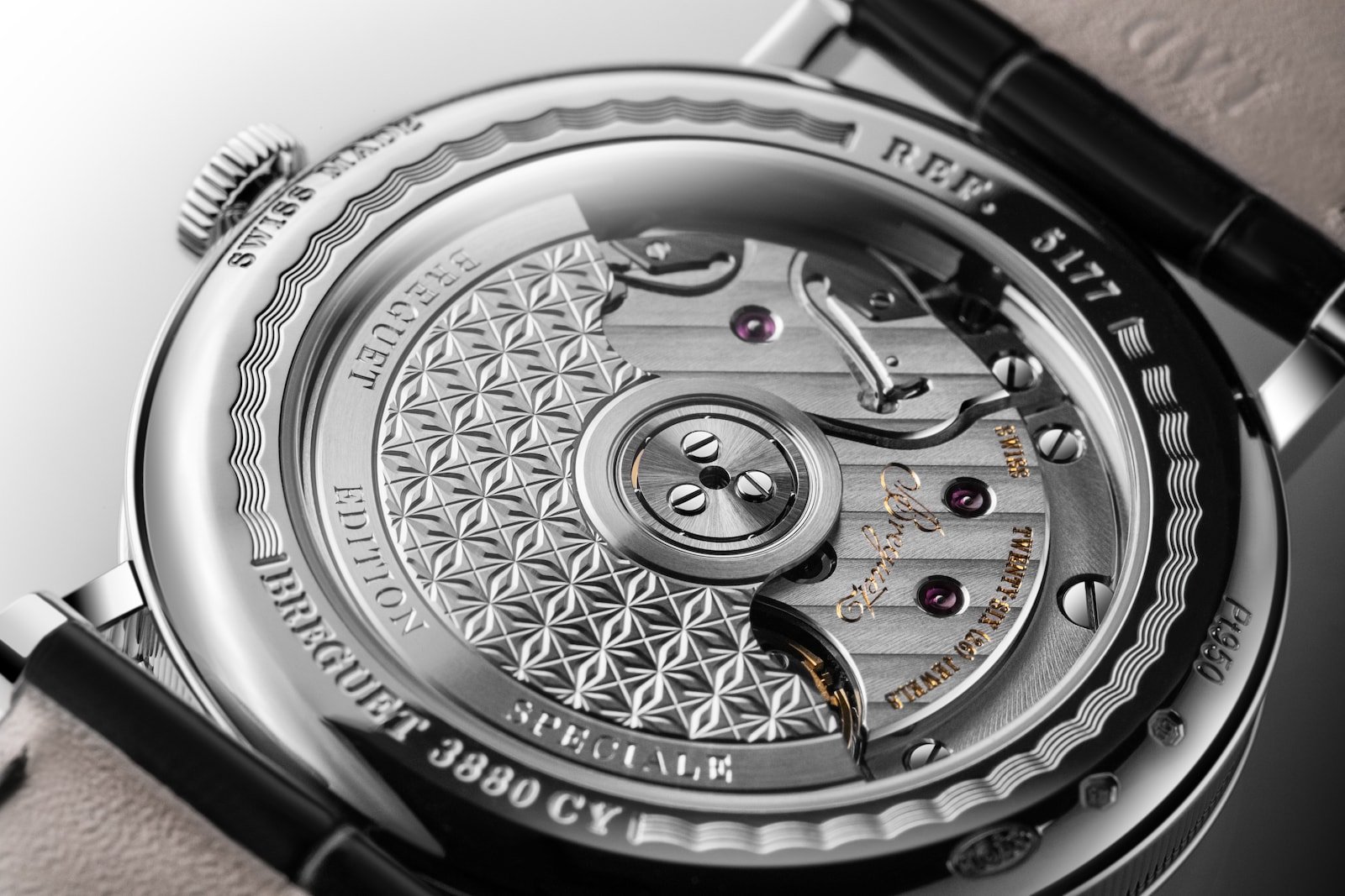 Decorated automatic movement visible through a Breguet Classique caseback.