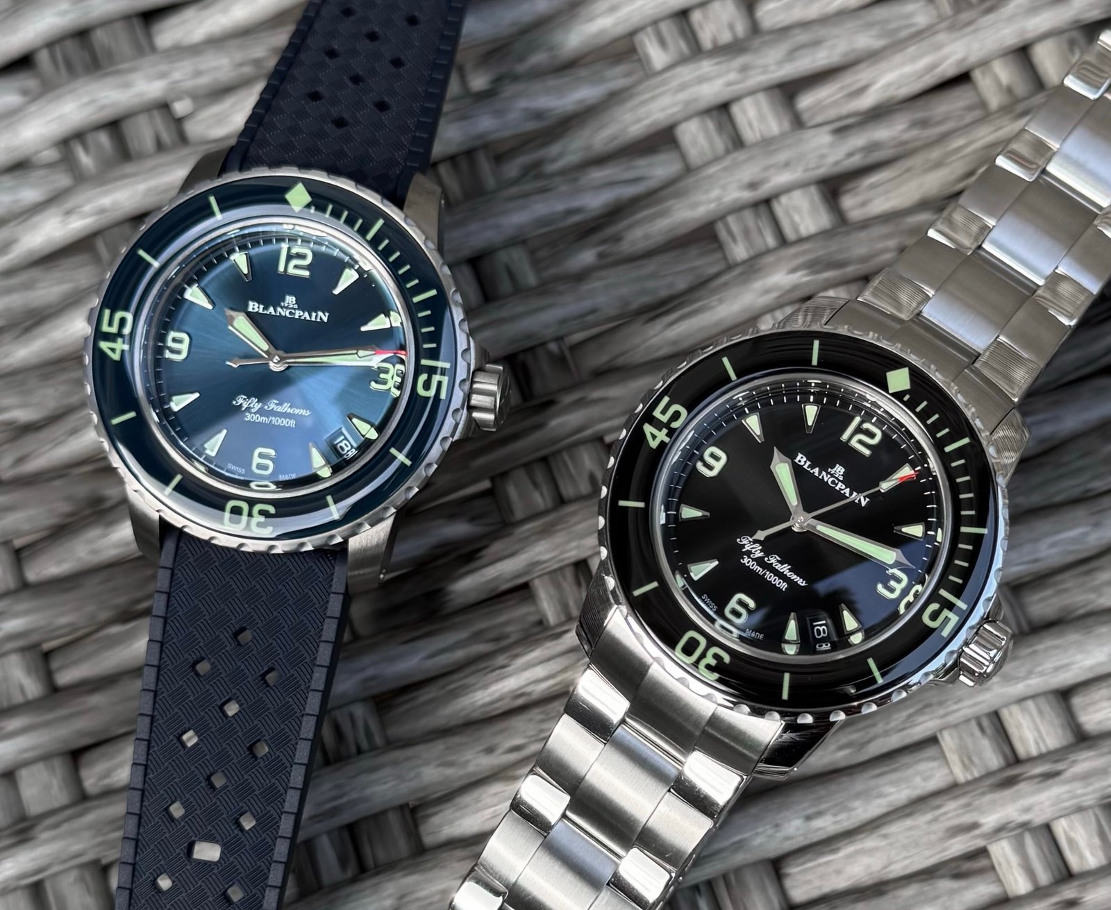 Two compact Blancpain Fifty Fathoms Automatique watches with blue and black dials.
