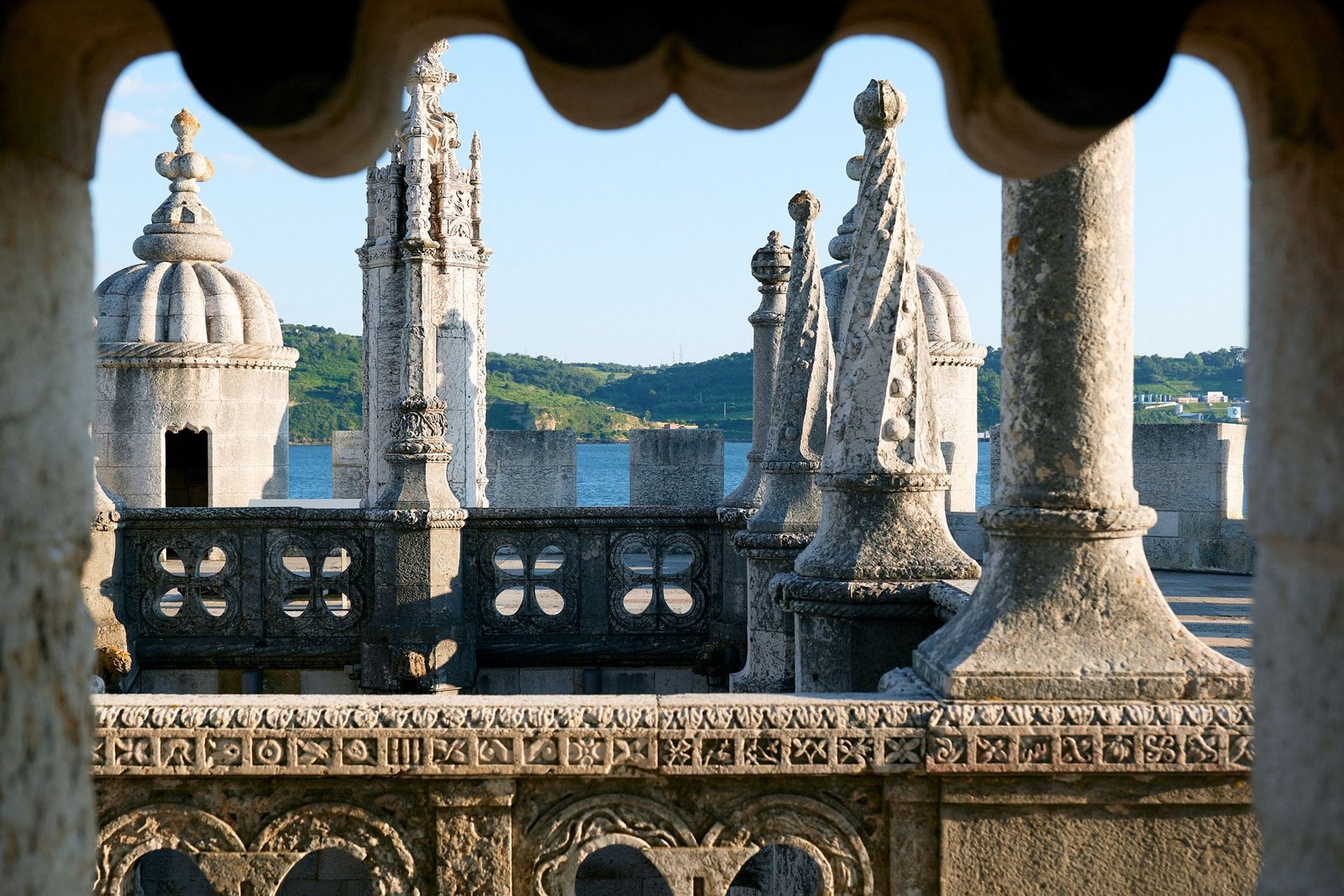 Decorative terrace details at Belém Tower with the river beyond.