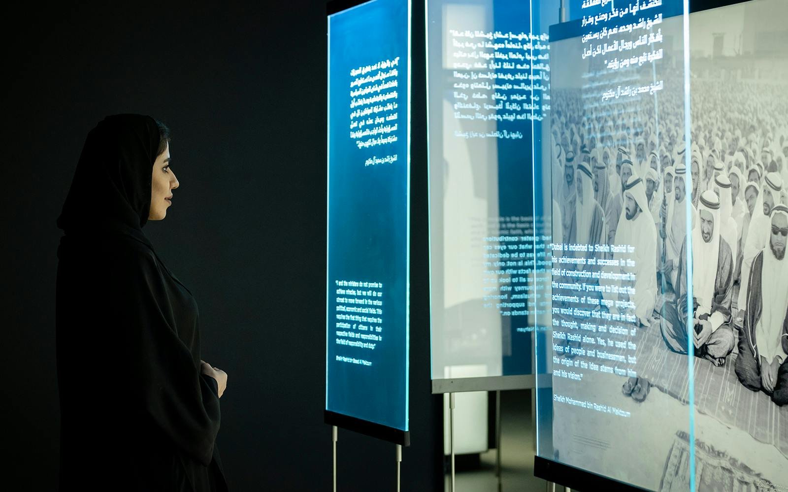 Visitor viewing illuminated historical displays at Al Shindagha Museum