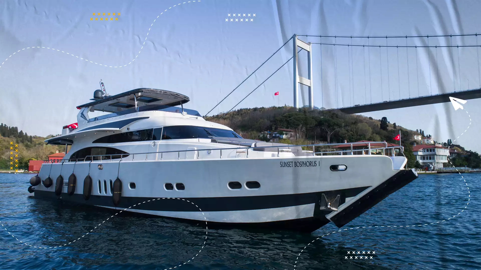 A yacht on the Bosphorus beneath the suspension bridge.