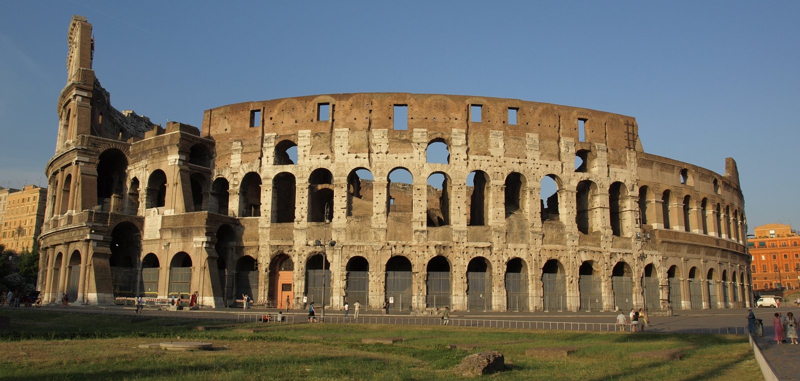 The Colosseum in Rome illuminated by warm evening sunlight.