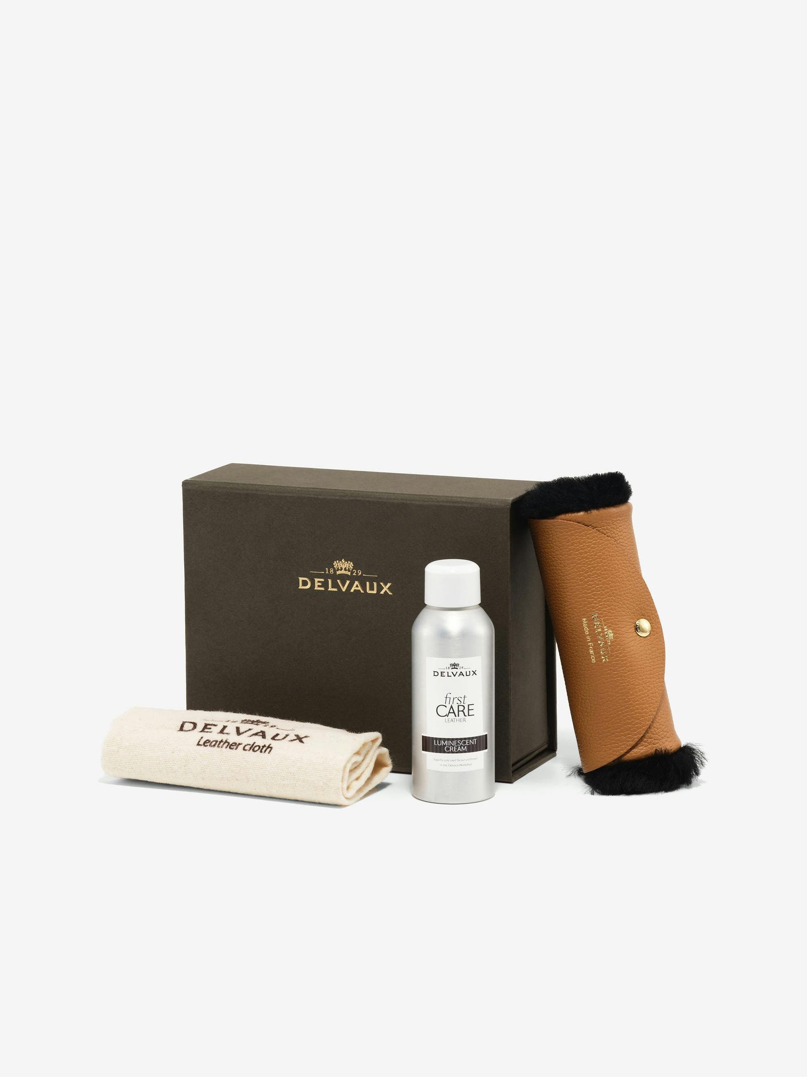 Delvaux leather care kit displayed against a clean background.