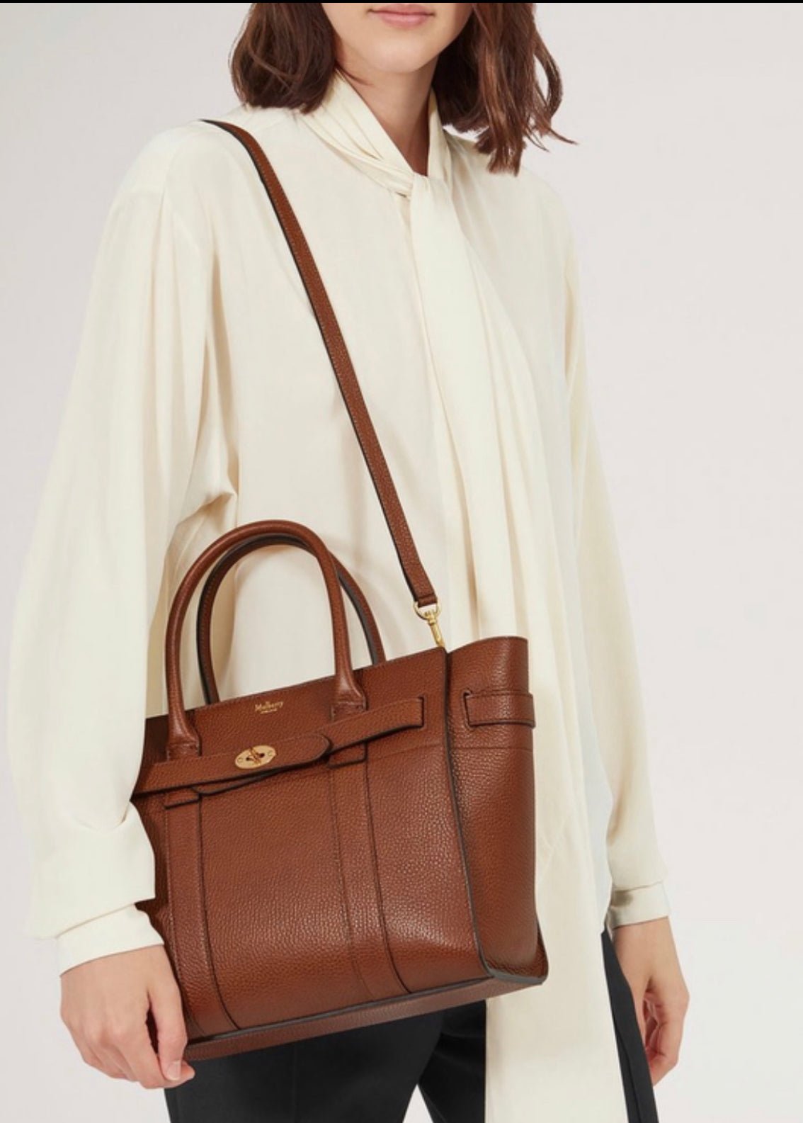 Model carrying an Oak Small Zipped Bayswater