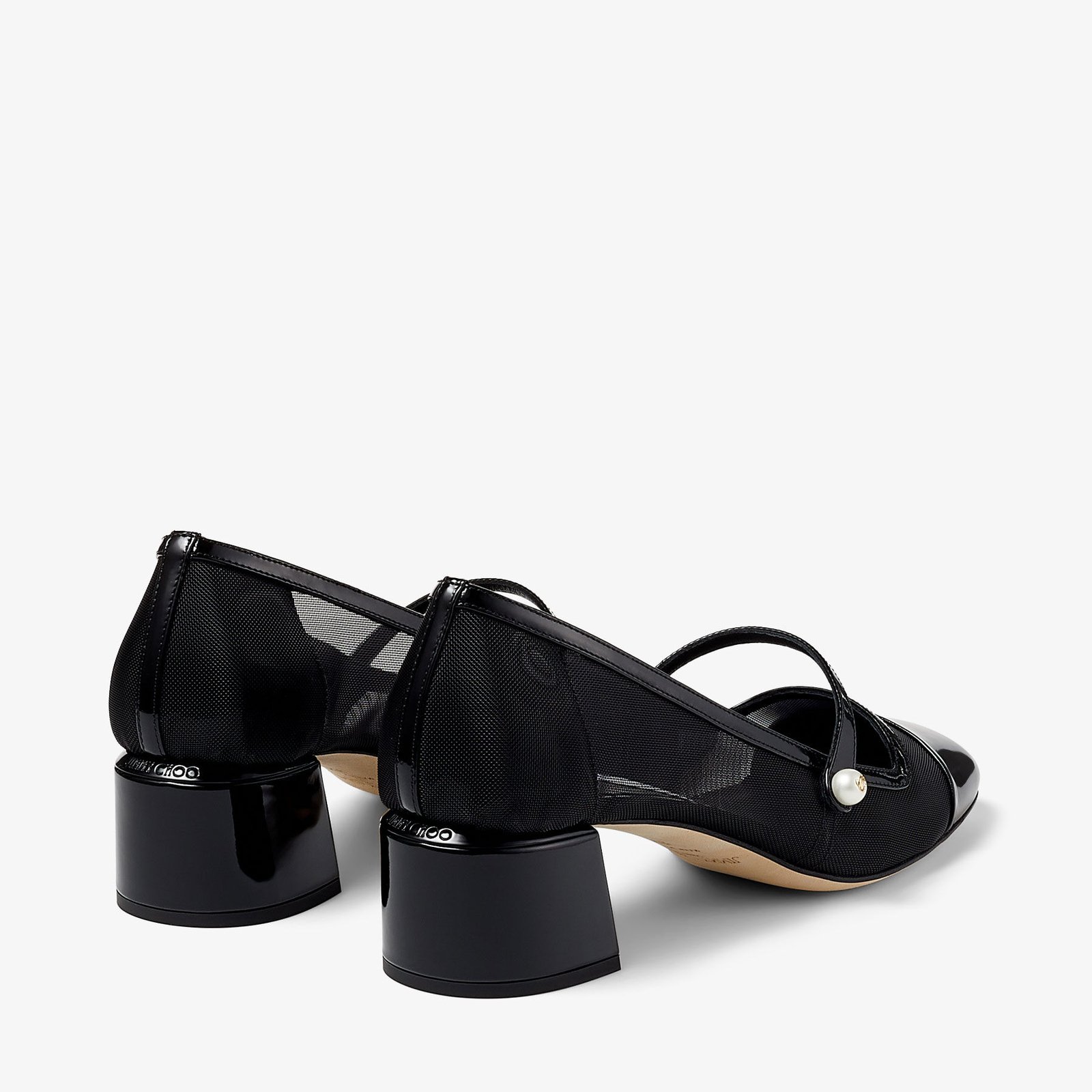 Rear view of black mesh pumps showing their low block heels