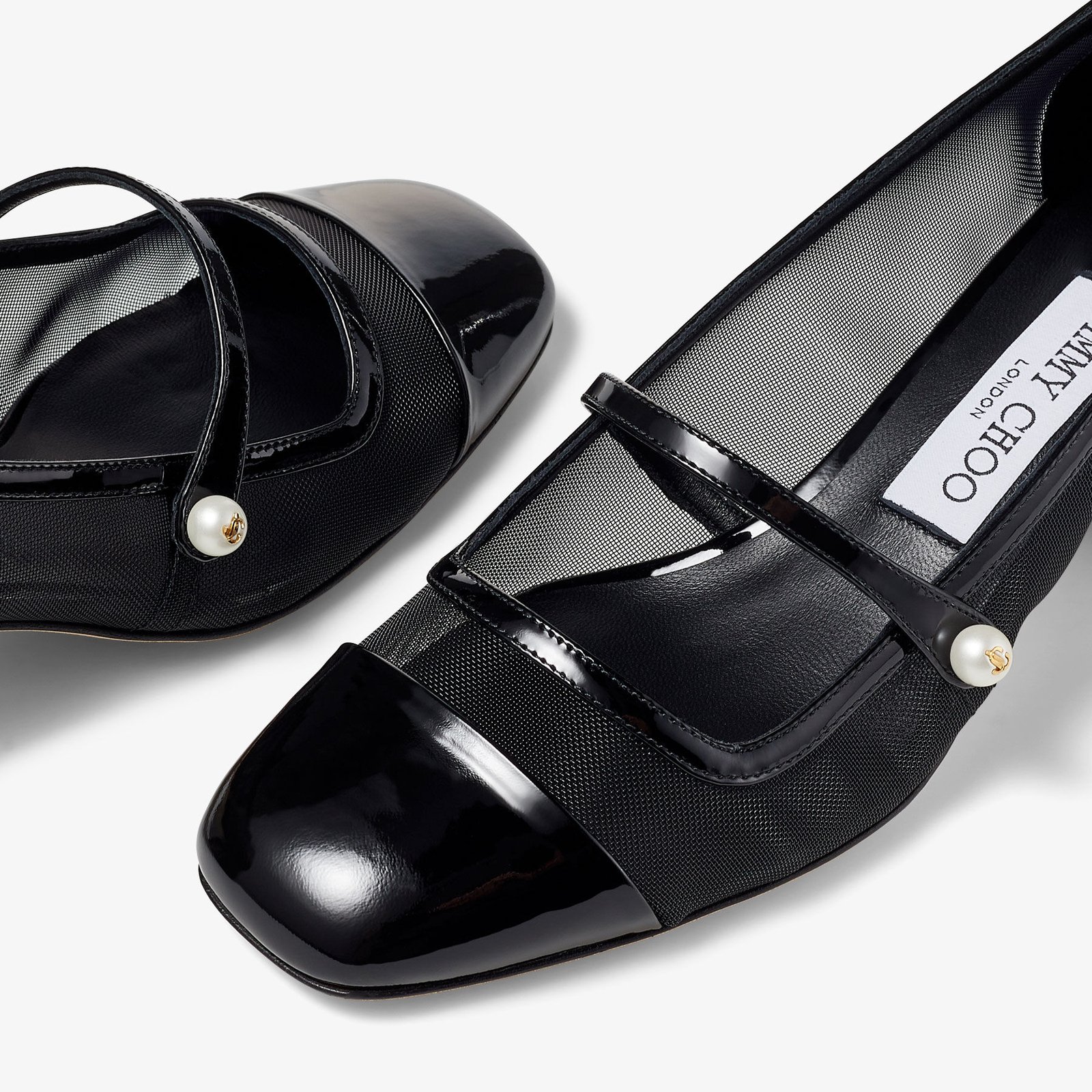 Close-up of mesh pumps showing reinforced edging and opaque toe coverage