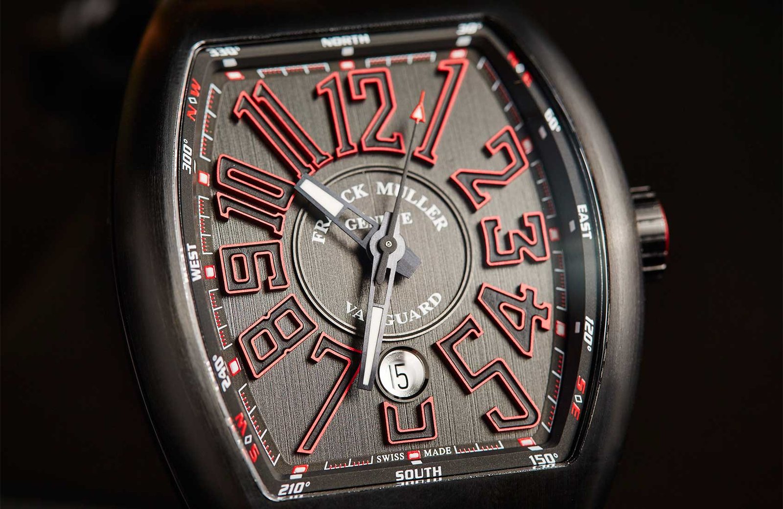 Close view of a dark Vanguard dial with expressive Arabic numerals.