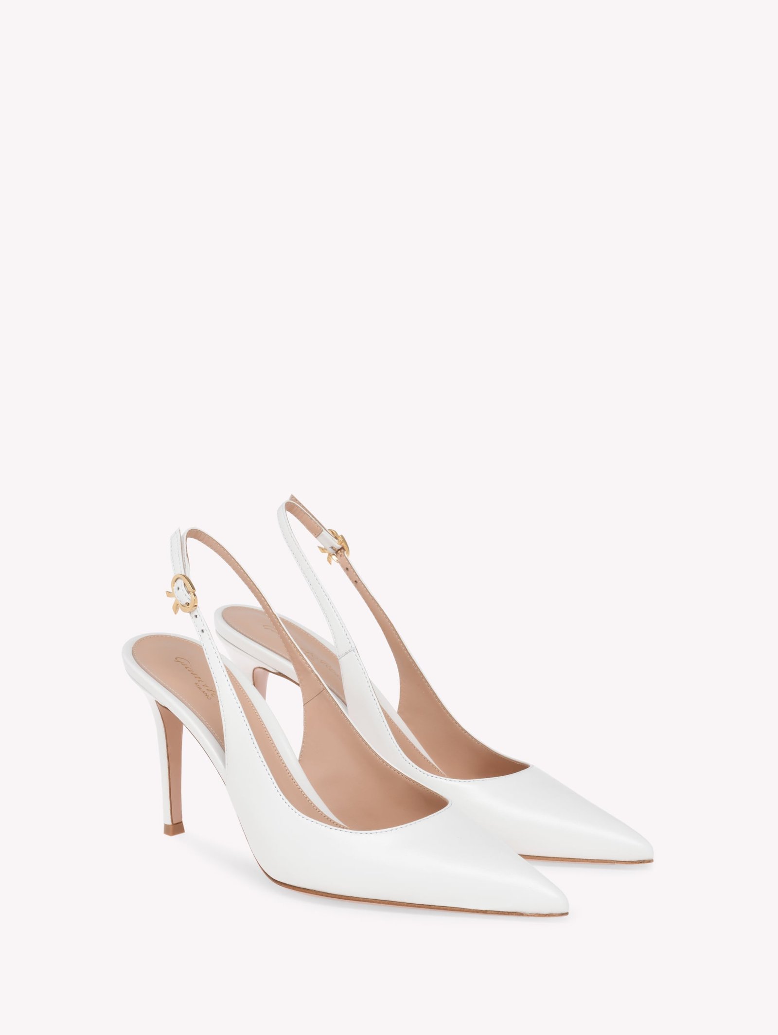 White nappa Ribbon Sling 85 heels with metallic buckles.