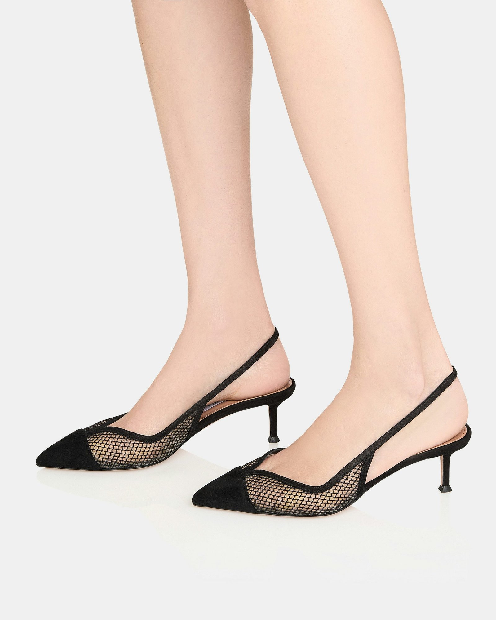 Black mesh slingback heels worn on feet