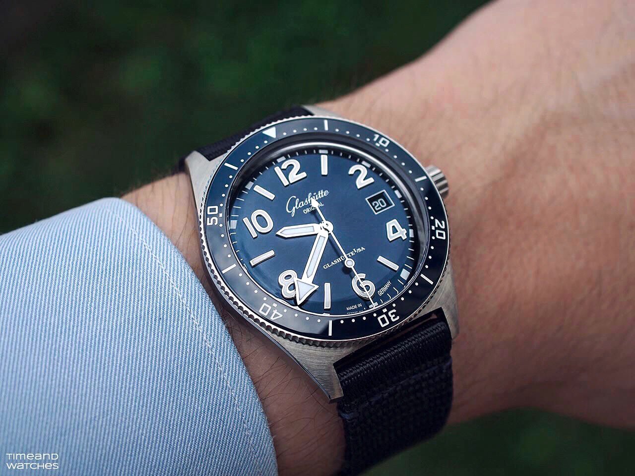 Blue SeaQ worn on a synthetic strap beside a shirt cuff.