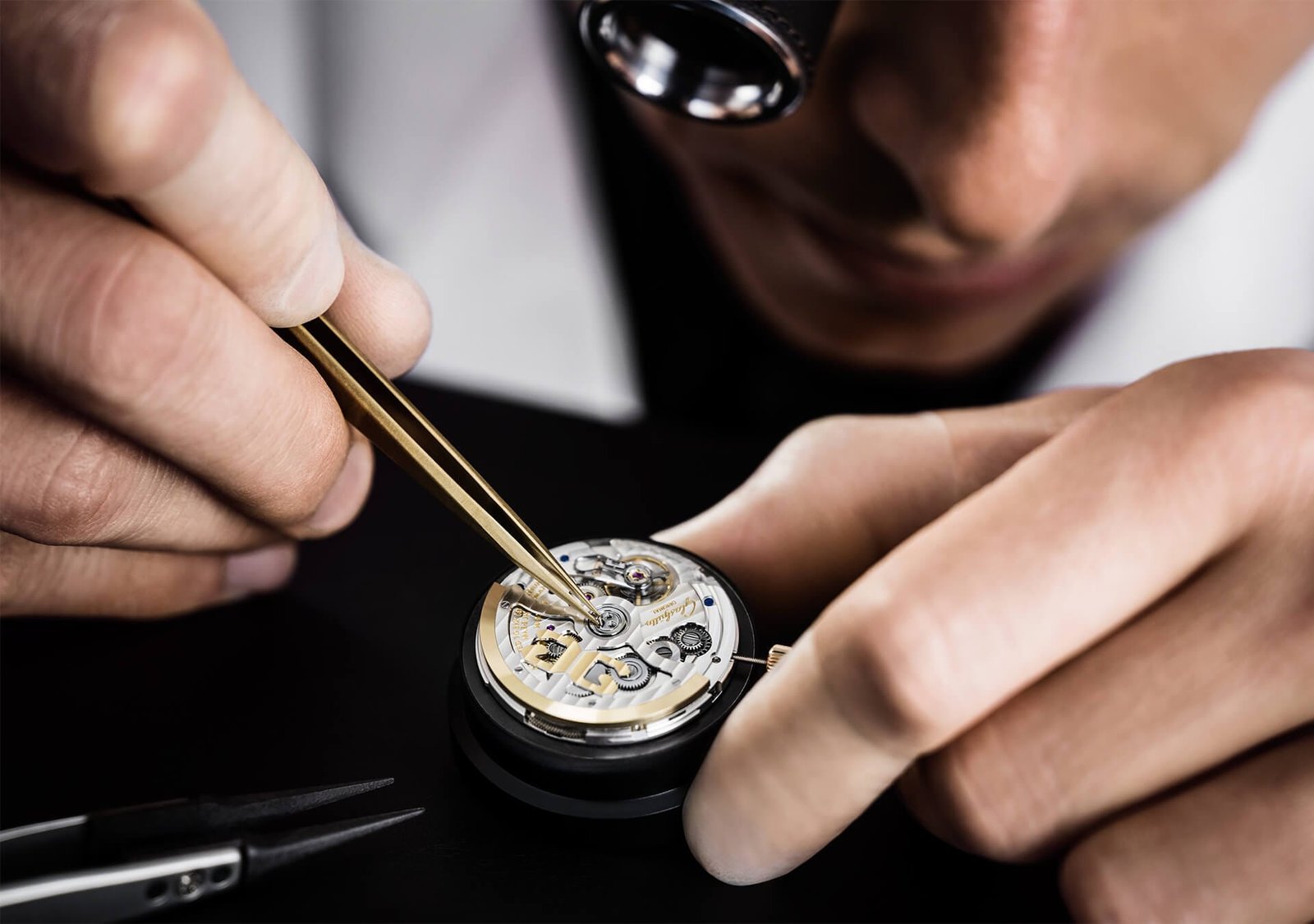 Watchmaker working on a mechanical movement at Glashütte Original.