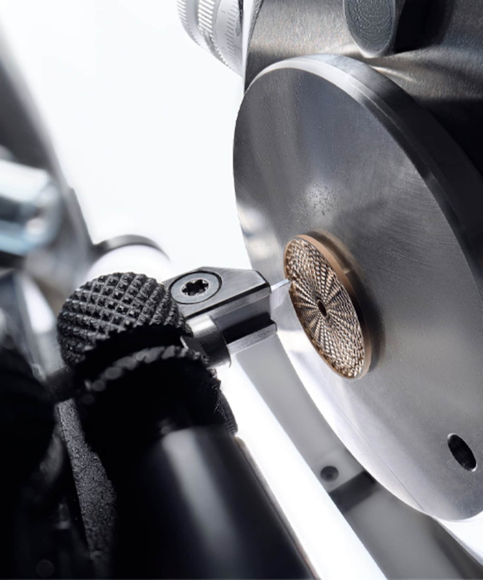 Hand-operated engine-turning equipment engraving a Breguet watch dial.