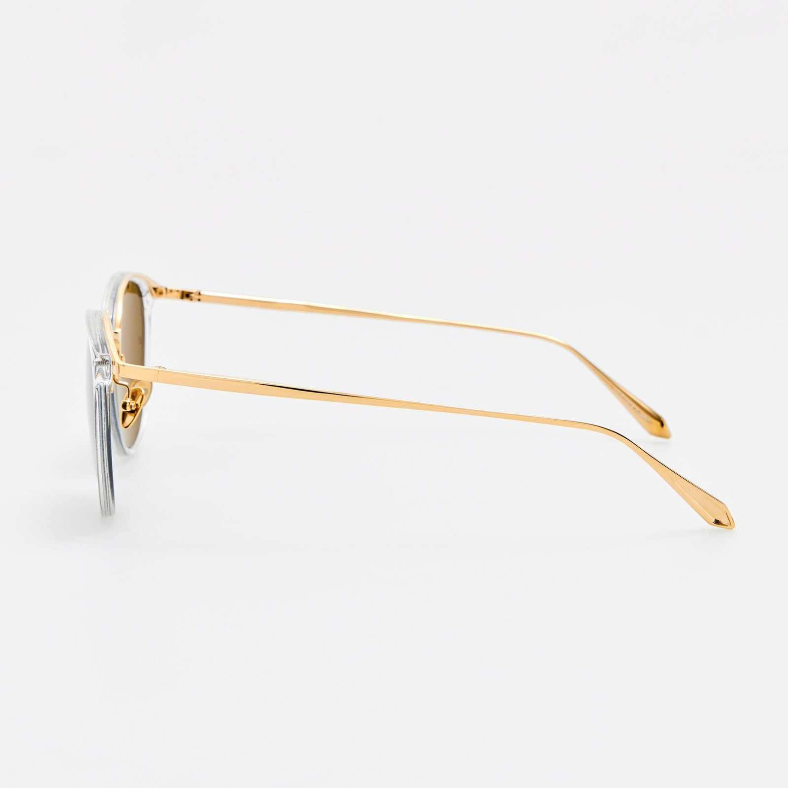 Side view of Calthorpe sunglasses showing clear acetate rims and gold-tone titanium temples.