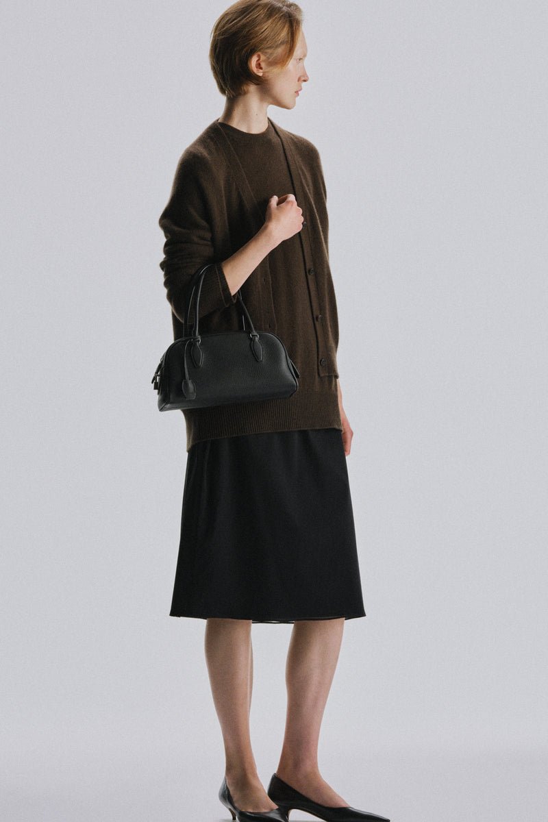 The Row Small E/W India bag styled in an editorial image.