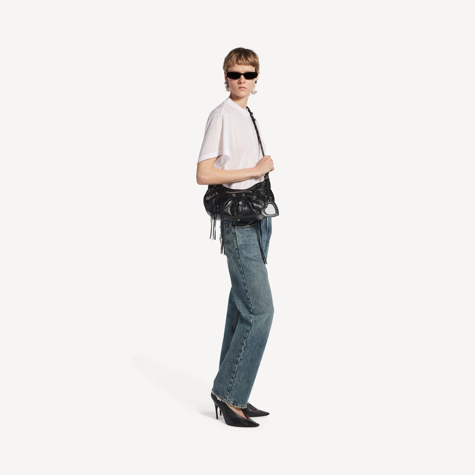 Model styling a black Balenciaga Le Cagole Small with a white shirt and denim.