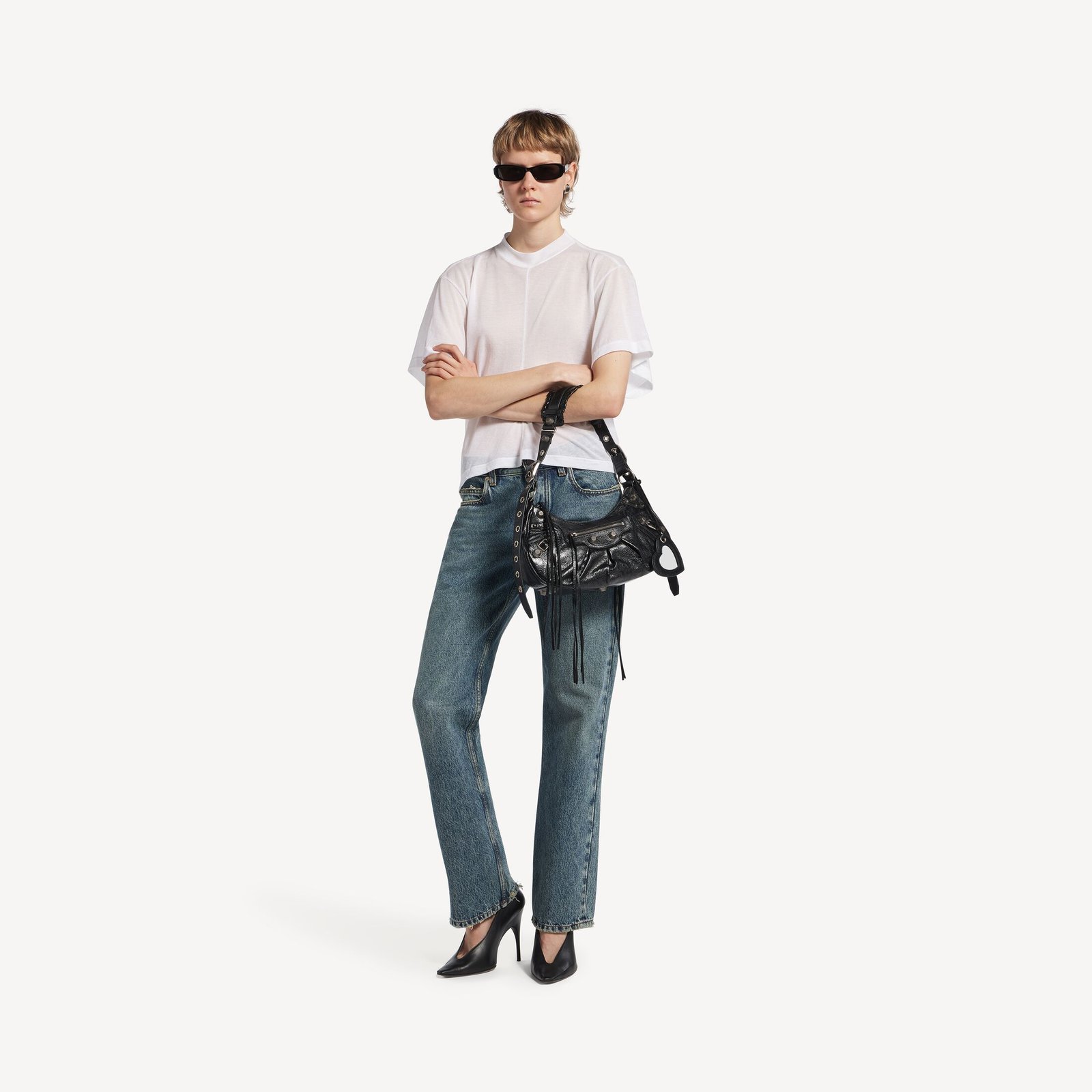 Model carrying the black Balenciaga Le Cagole Small to show its proportions against the body.