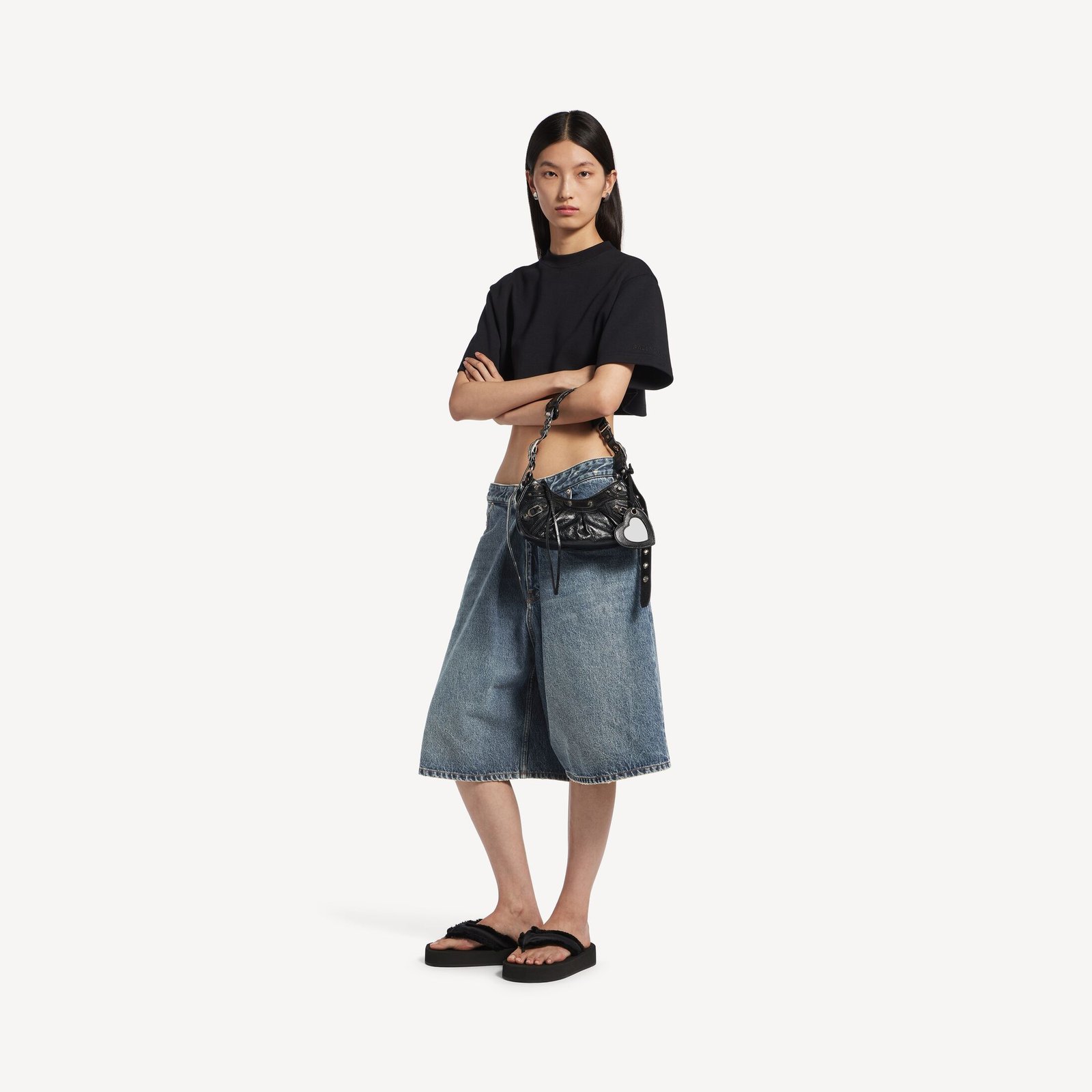 Model wearing a black Le Cagole XS with a plain tee and denim skirt.