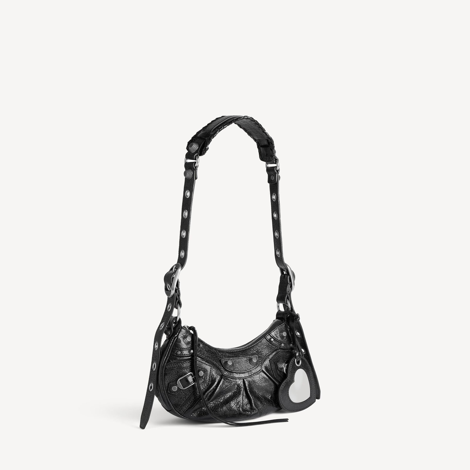 Black Balenciaga Le Cagole XS bag with aged-silver hardware and heart mirror.
