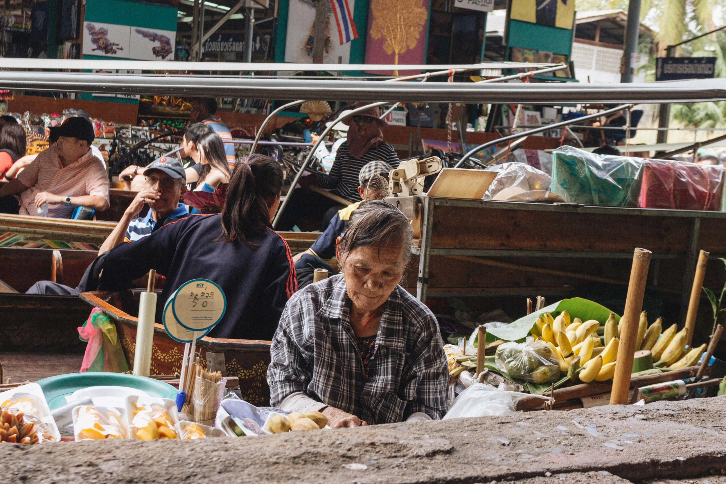 Food and fruit vendor beside passenger boats at Damnoen Saduak.