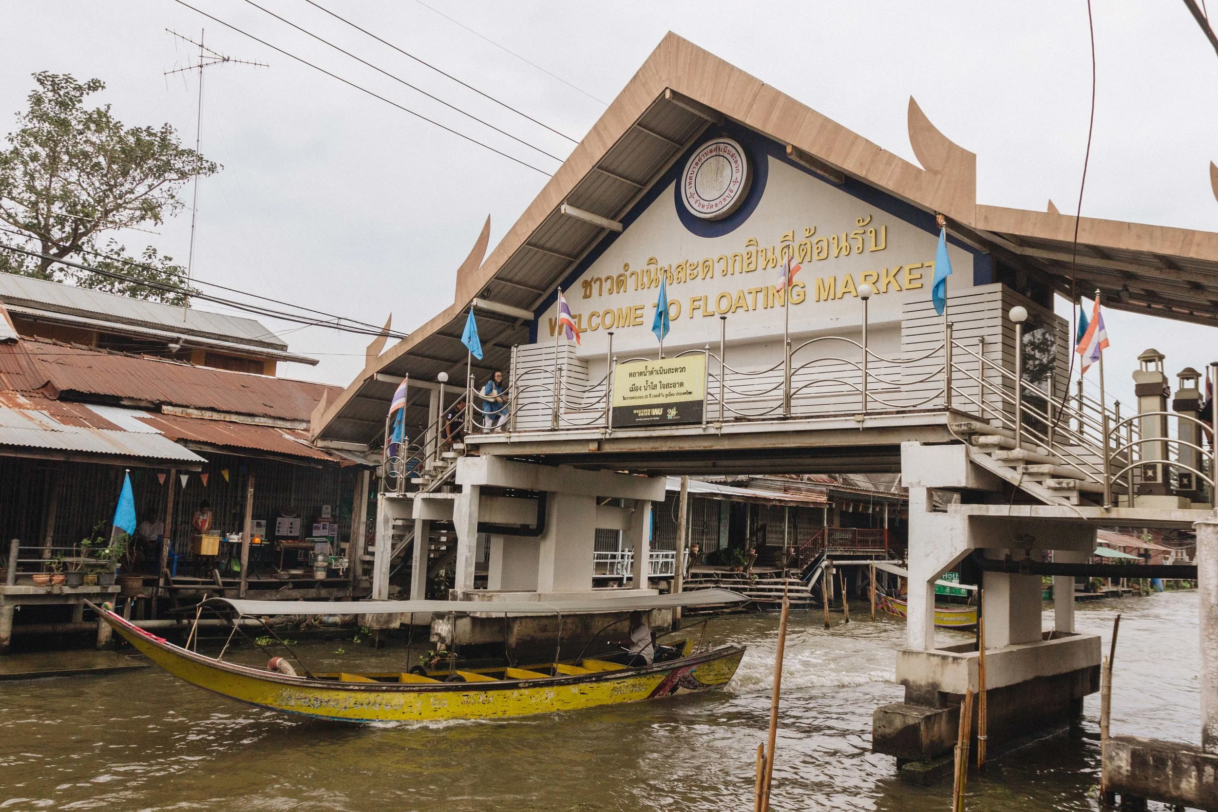 Market building and boats beside a Damnoen Saduak canal.