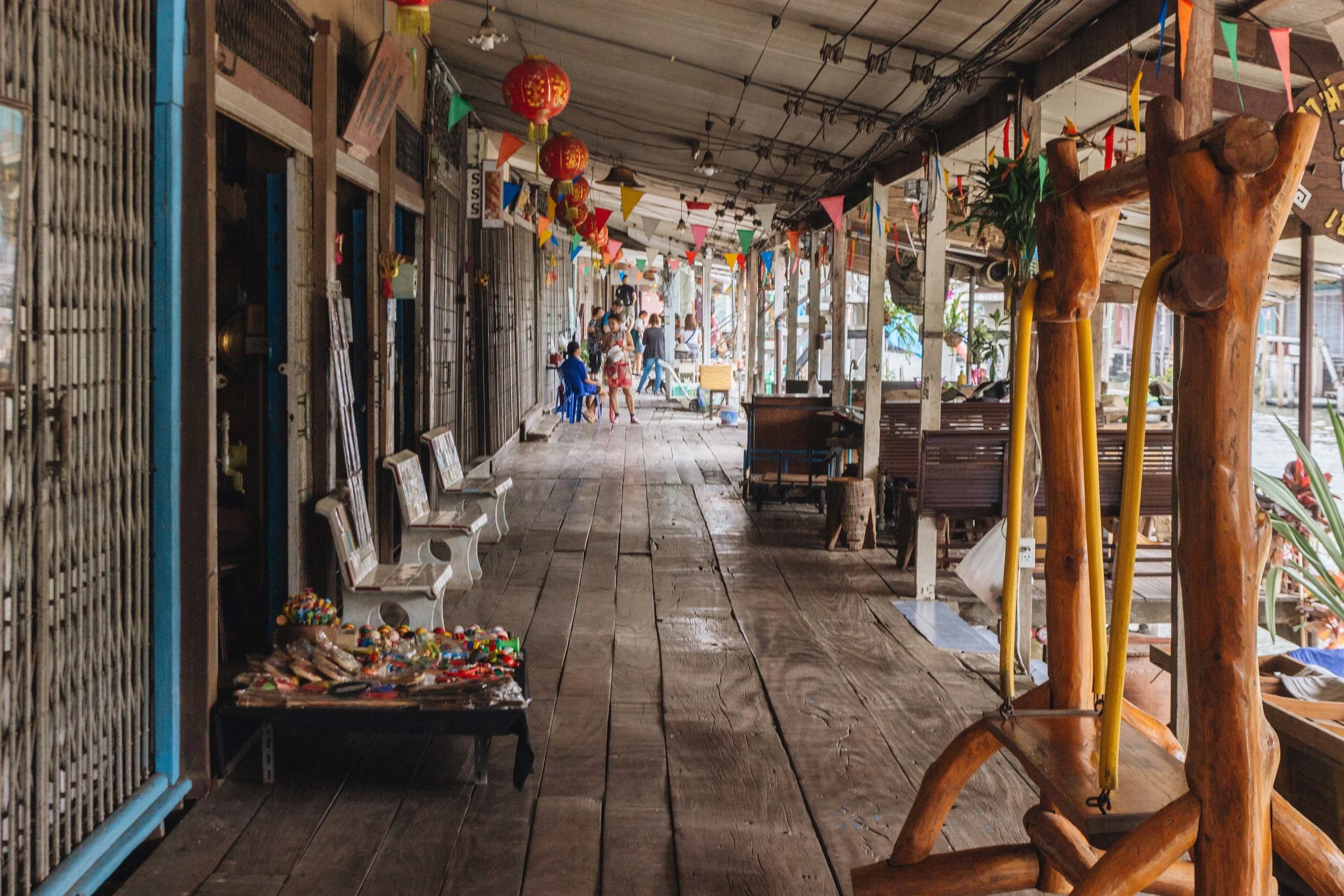 Wooden walkway beside the canal-side market stalls.