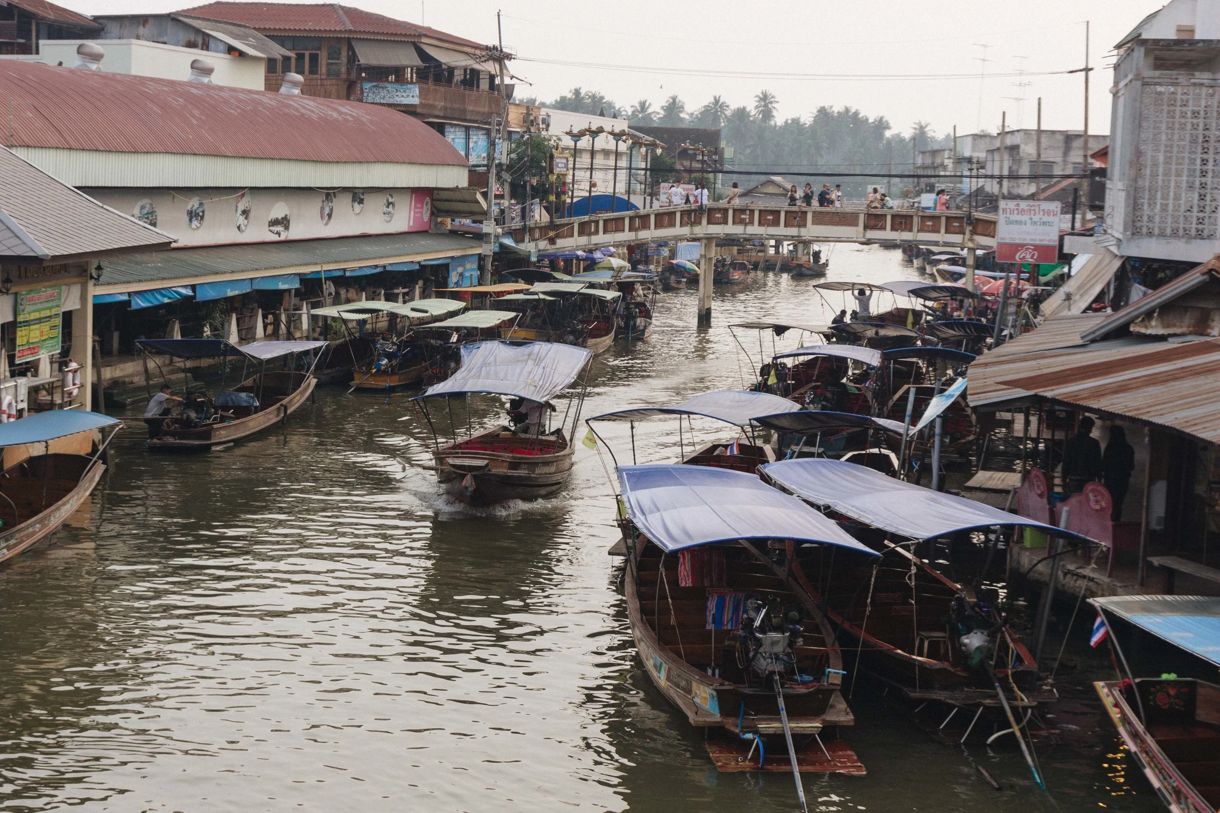 Market canal lined with boats and covered stalls.