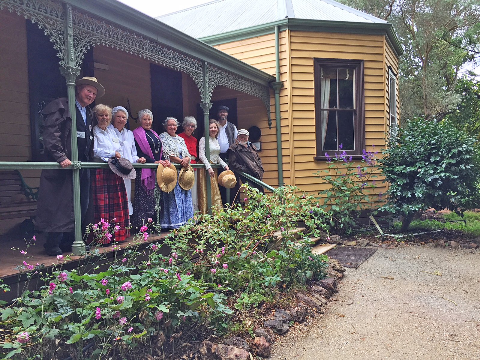 Visitors outside a heritage building at Churchill Island.