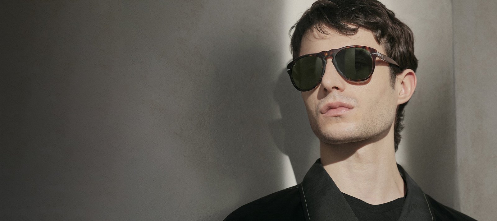 Model wearing Persol 649 sunglasses in a close portrait.