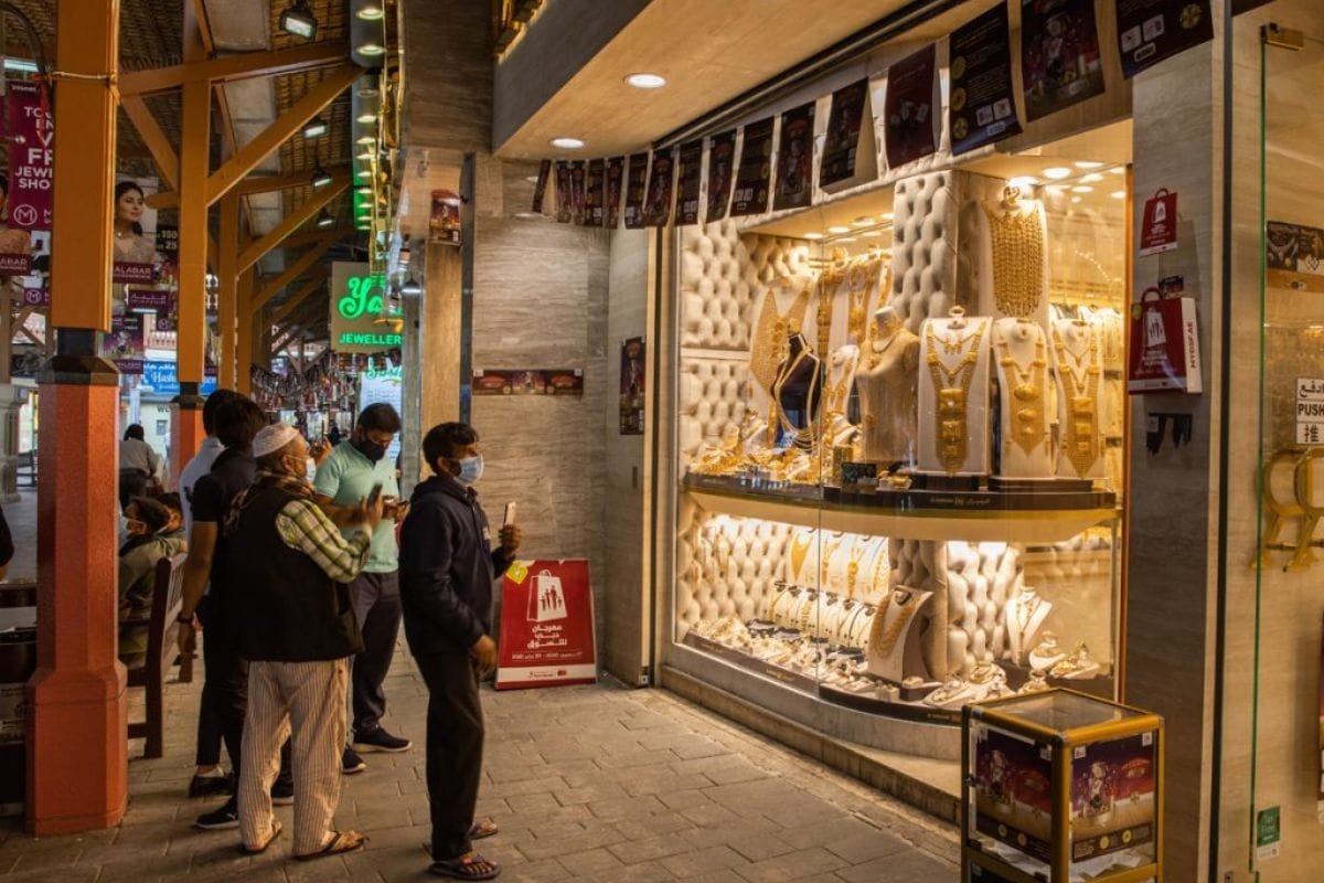 Visitors beside jewellery displays in Dubai’s Gold Souk