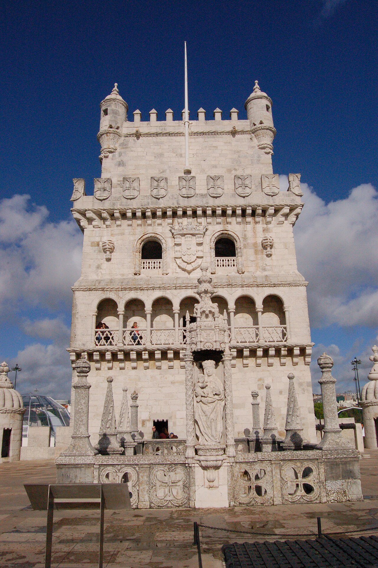 The decorated facade of Belém Tower against a blue sky.