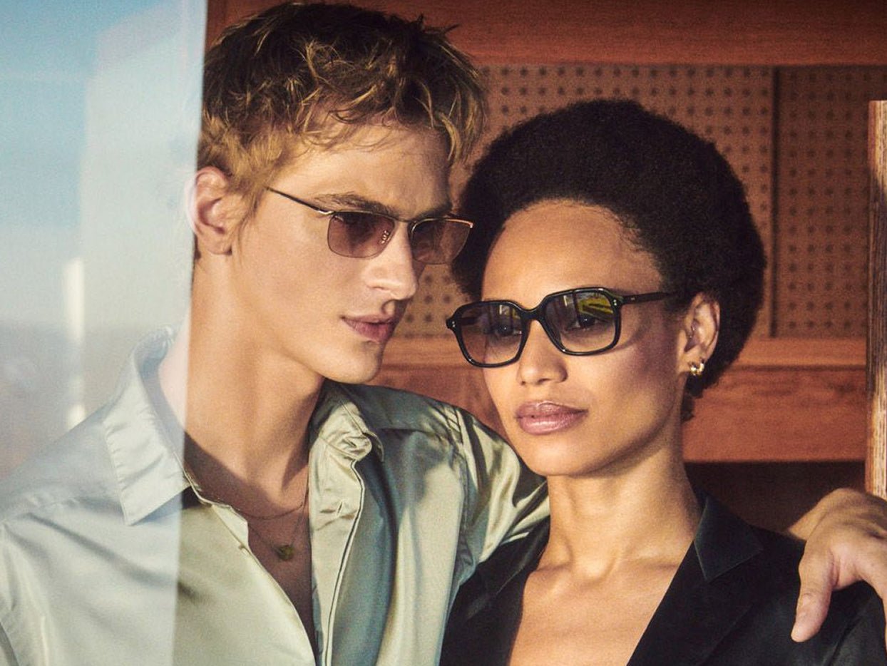 Two models wearing Oliver Peoples eyewear with relaxed clothing