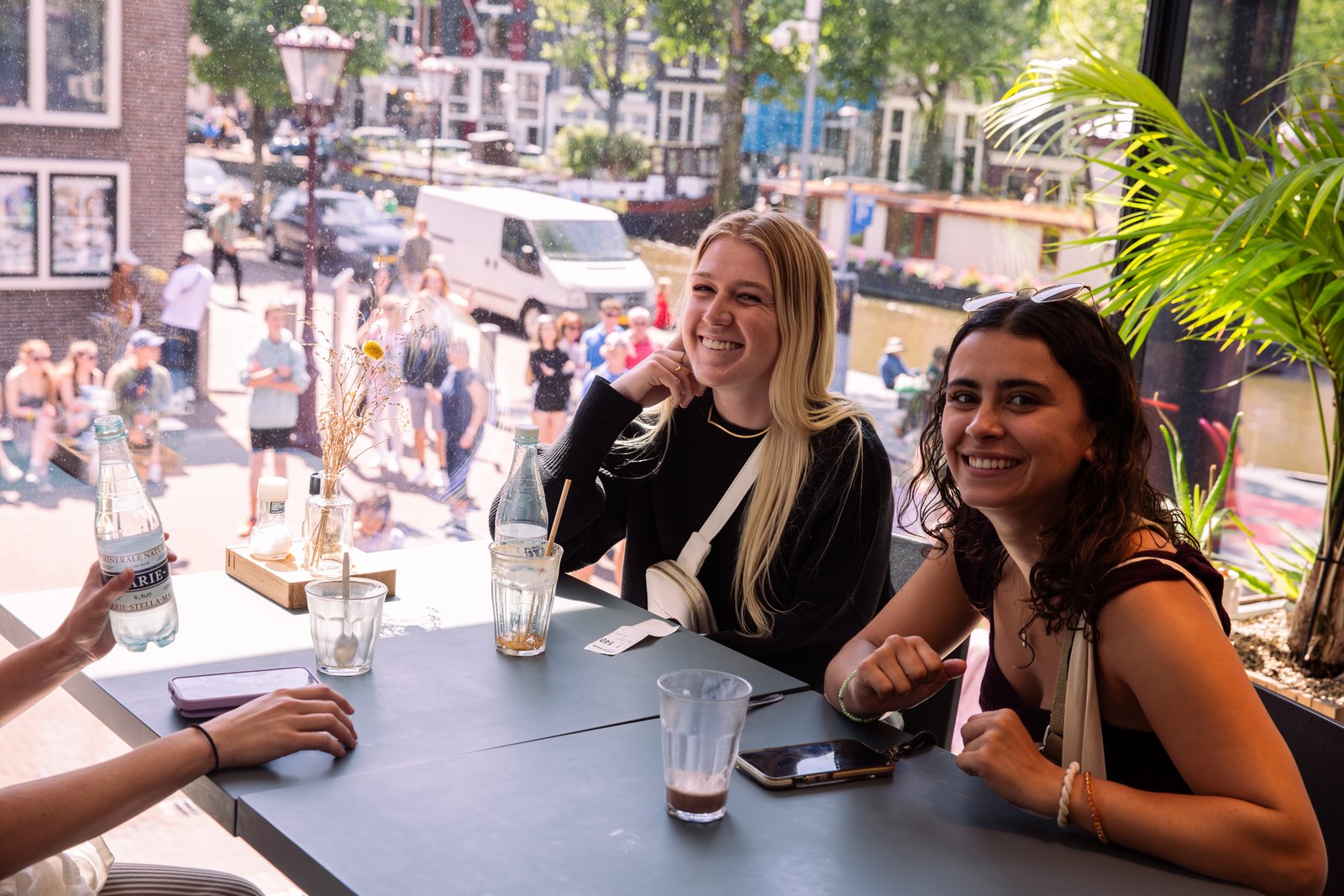 Visitors seated in the museum café overlooking the canal.