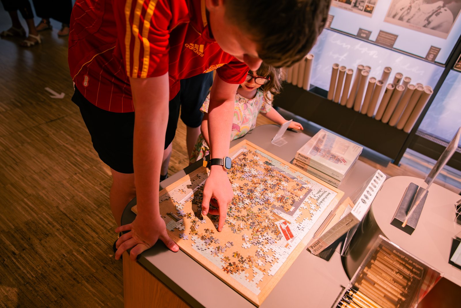 Museum visitor reading a book in the museum shop.