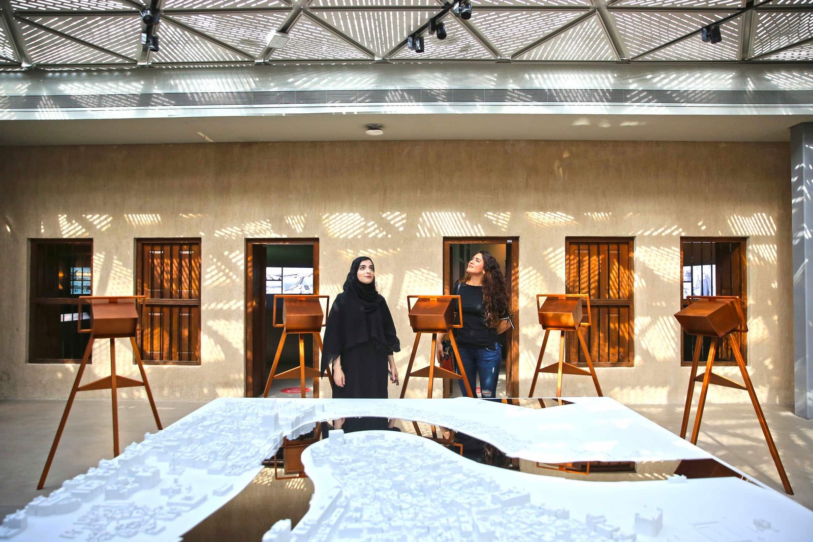 Visitors studying a Creek heritage model at Al Shindagha Museum