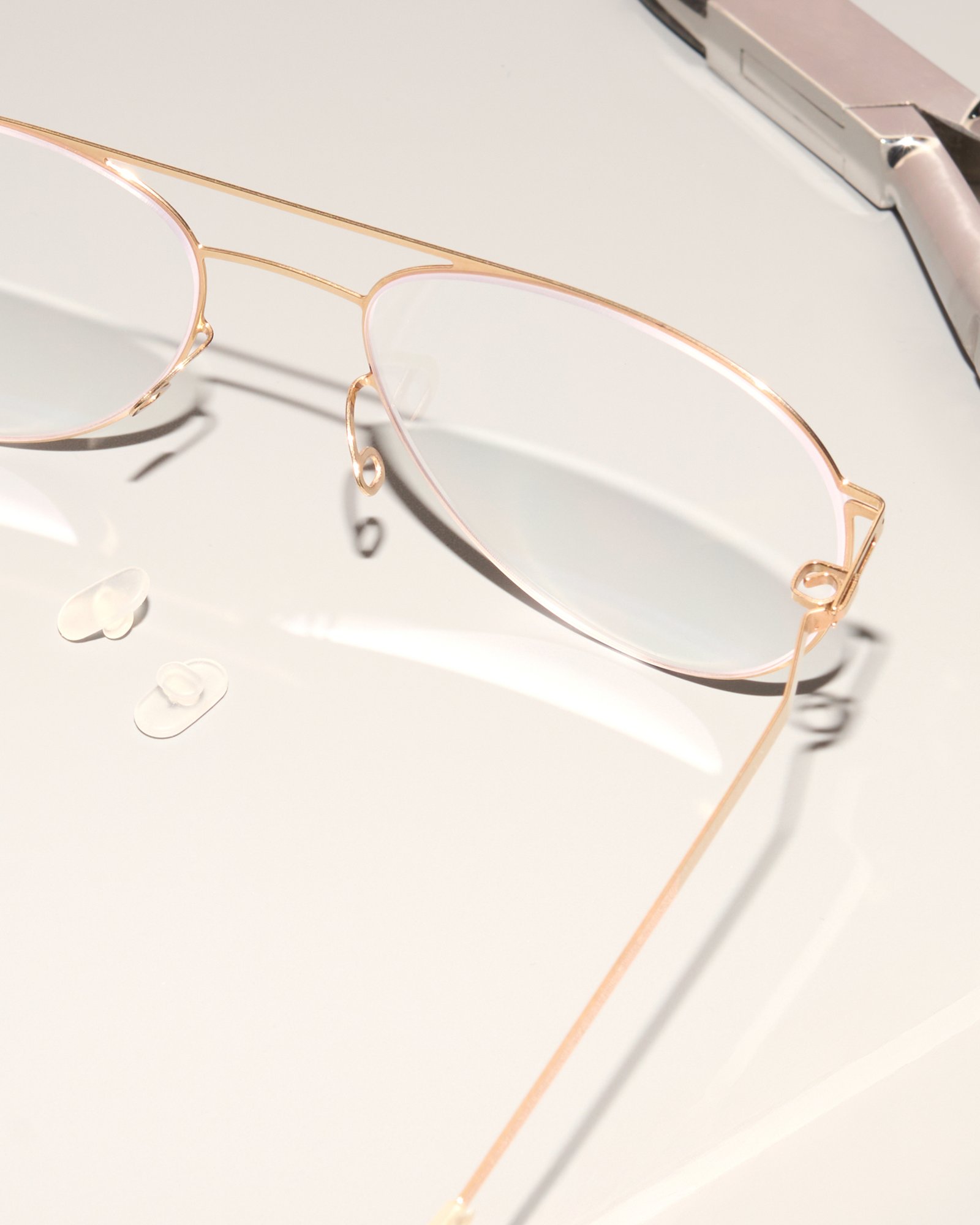 Close-up of a fine MYKITA metal frame, nosepads and temples during aftercare.