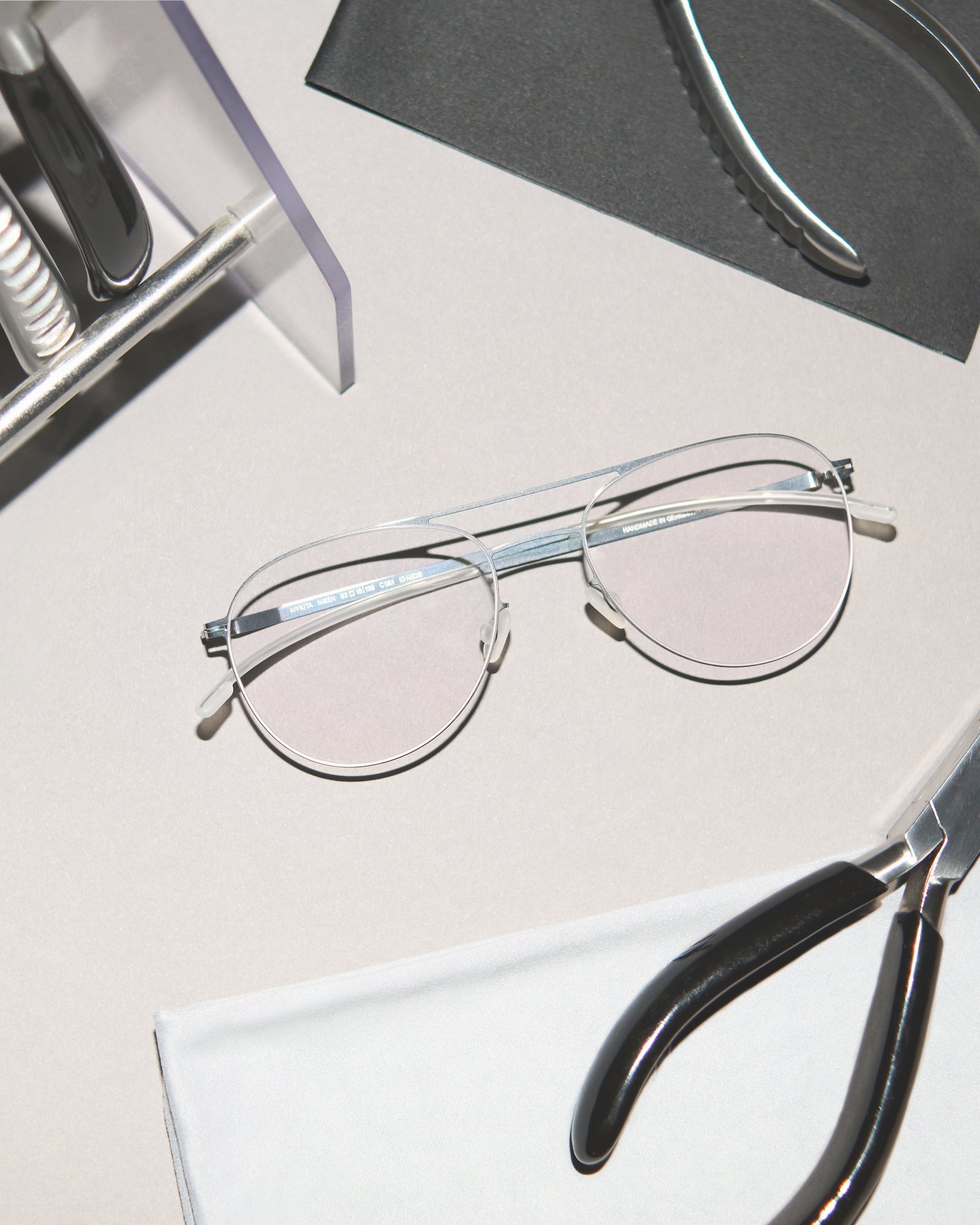 MYKITA optical glasses and tools prepared for professional maintenance.