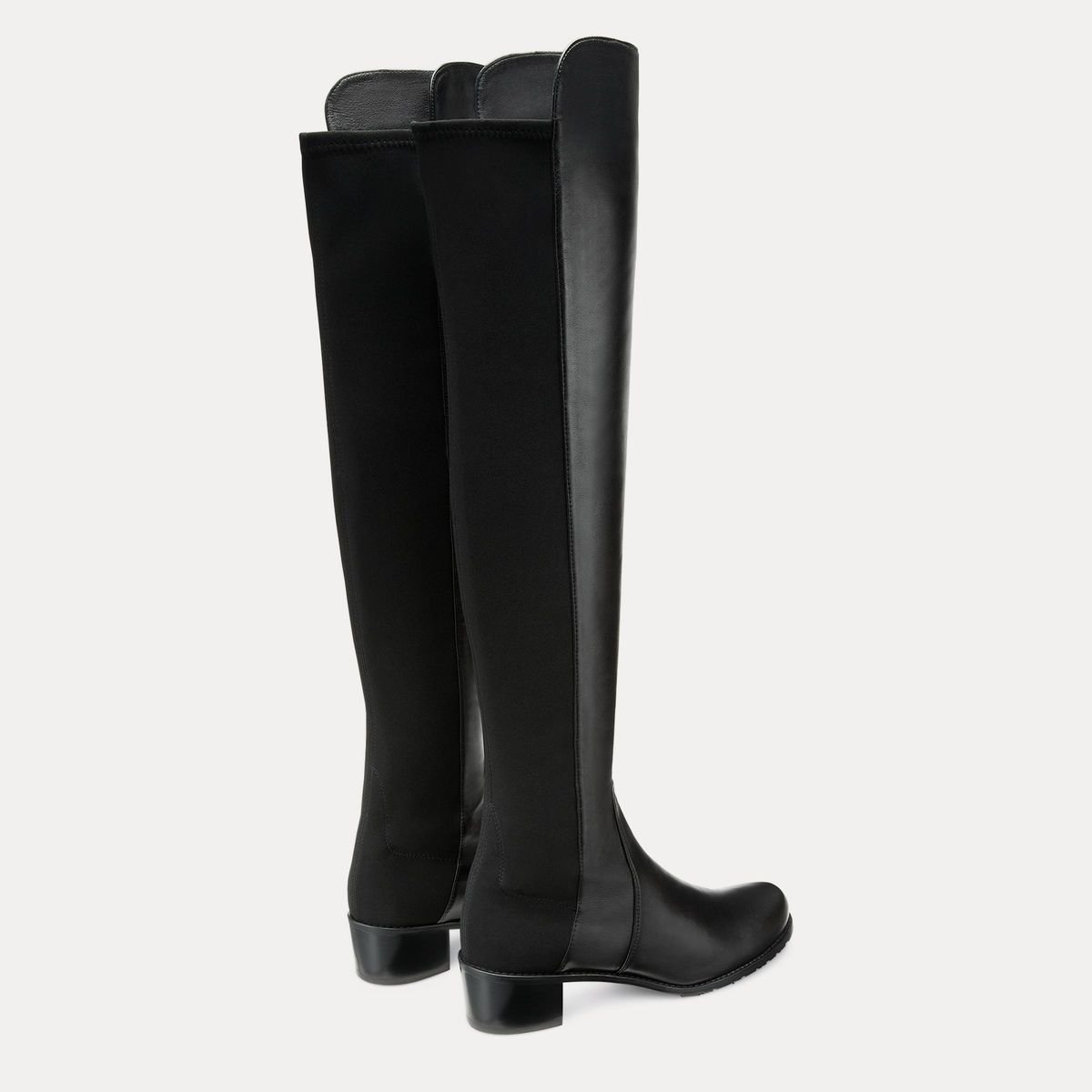 Rear view of black Stuart Weitzman Reserve boots showing their tall stretch shafts.