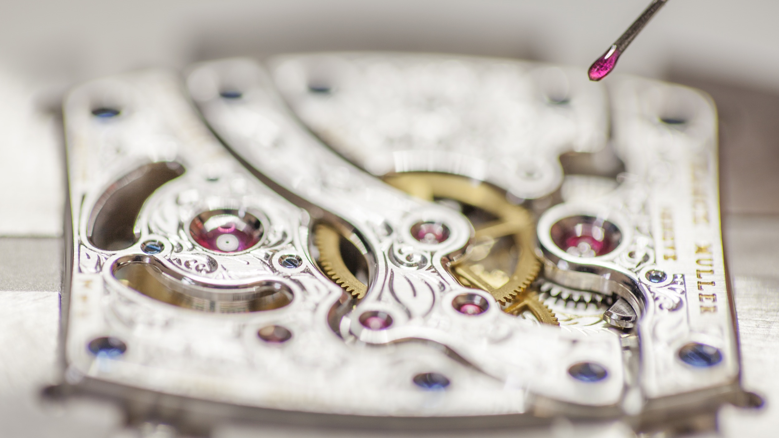 Close-up of a Franck Muller mechanical movement during inspection.