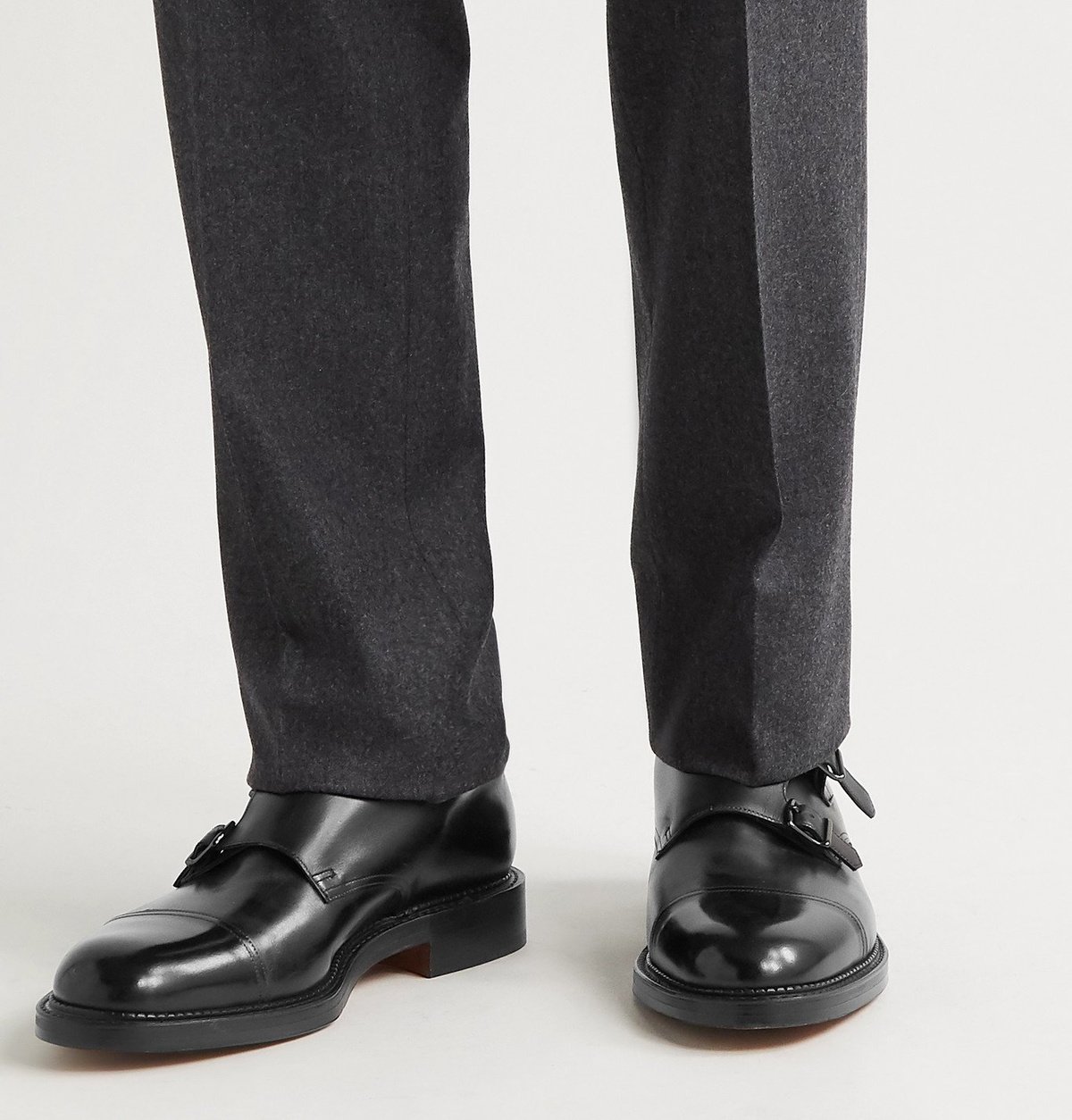 John Lobb William double monk shoes worn with grey tailored trousers.
