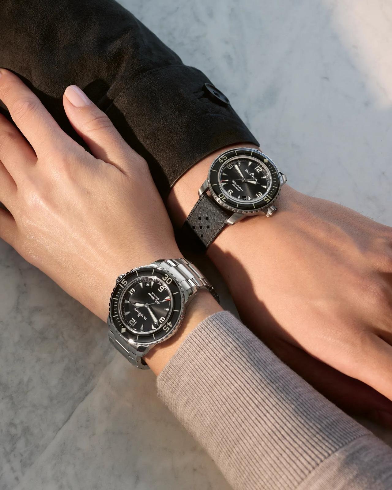 Two Blancpain Fifty Fathoms watches worn on wrists with different straps and bracelets.