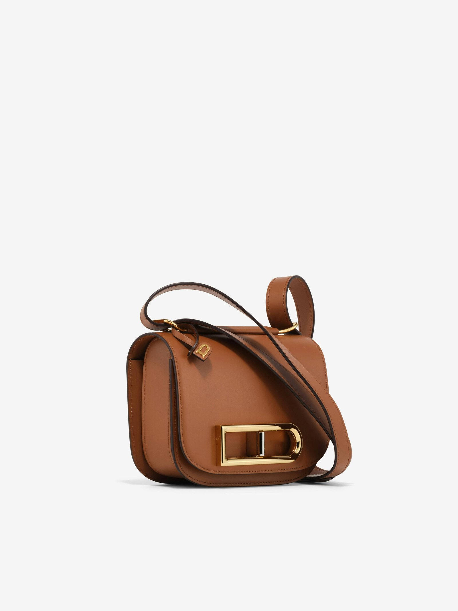 Tan Delvaux Lingot Small with its distinctive metallic D clasp.