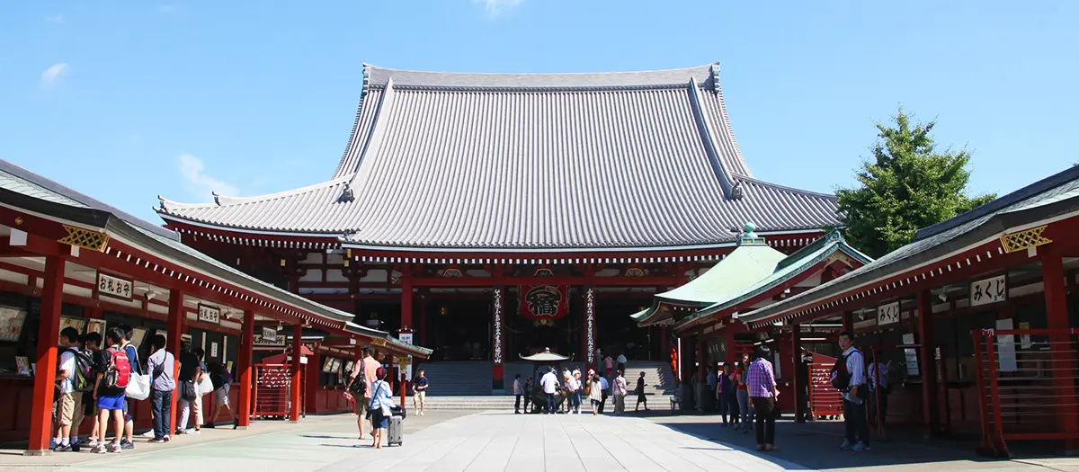 Senso-ji’s main hall beneath a clear blue sky.