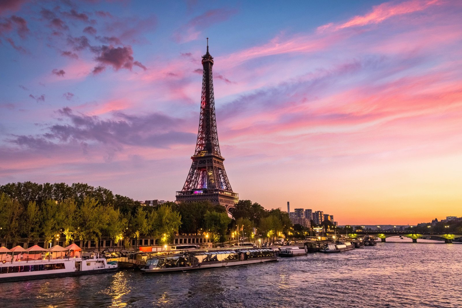 Eiffel Tower and Seine River at sunset during a first day in Paris.