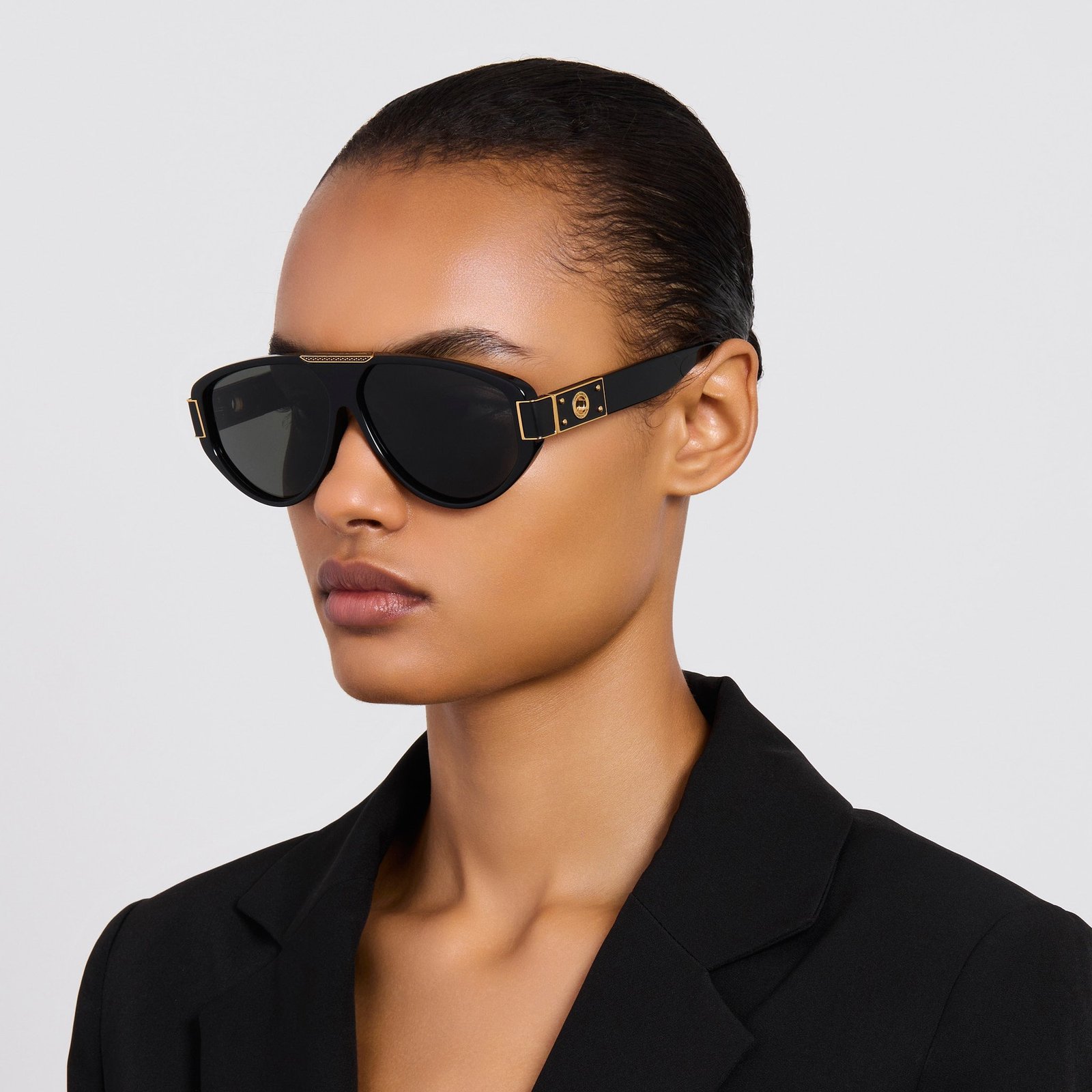 Model wearing black Linda Farrow Rowan aviator sunglasses to illustrate their proportions.