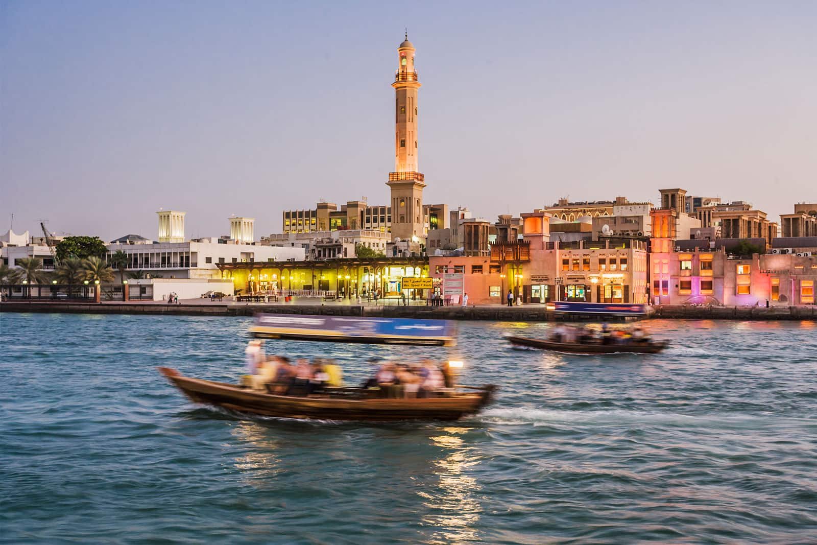 Abras crossing Dubai Creek as the waterfront lights begin to glow