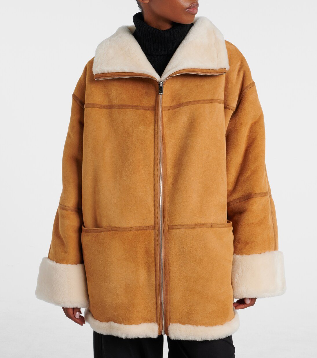 Matte suede exterior and fleece collar on a shearling jacket.
